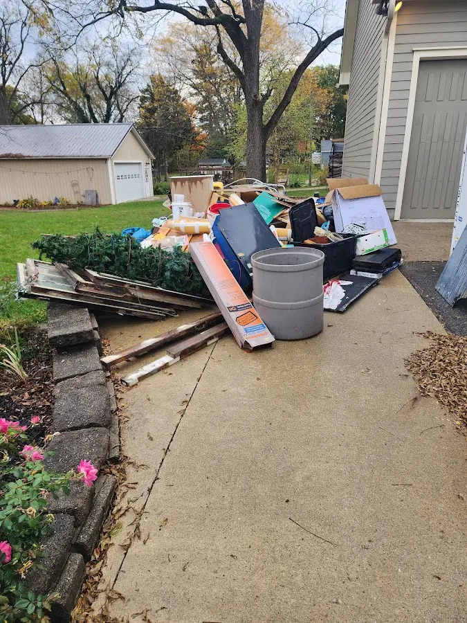 Dumpster being loaded with debris for Estate Cleanout Dumpster Rental in Goulds